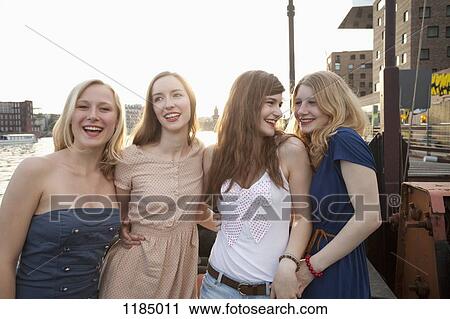 Four female friends standing side by side, Spree River, Berlin, Germany View Large Photo Image Stock Image - Four female friends standing side by side, Spree River, Berlin, Germany. Fotosearch