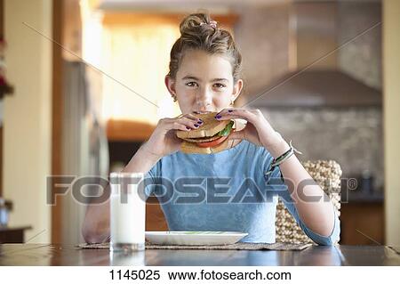 Stock Photography - Girl eating sandwich. Fotosearch
