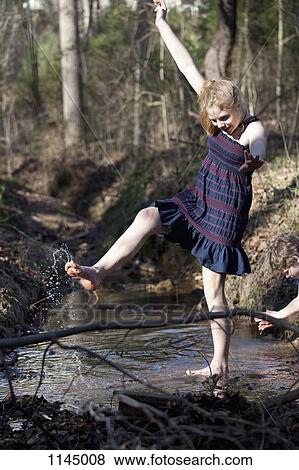 Girl kicking her feet through the water in Mooresville, North Carolina, USA View Large Photo Image Stock Photo - Girl kicking her feet through the water in Mooresville, North Carolina, USA. Fotosearch