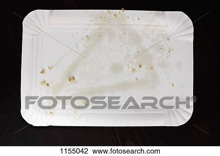Stock Image - Greasy stain from pizza slice on paper plate. Fotosearch