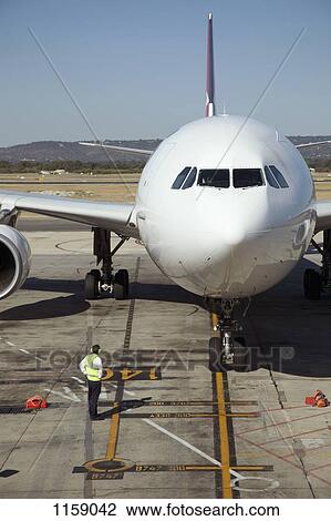Ground crew and jet on runway View Large Photo Image Stock Image - Ground crew and jet on runway. Fotosearch