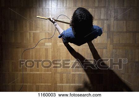 Guitarist in spotlight on stage View Large Photo Image Stock Image - Guitarist in spotlight on stage. Fotosearch