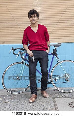 Guy leaning on bike holding camera View Large Photo Image Stock Photography - Guy leaning on bike holding camera. Fotosearch