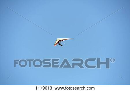 Stock Image - Hang glider against a clear blue sky. Fotosearch