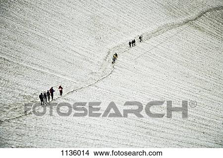Picture - Hikers ascending the Mutnovsky Volcano, Kamchatka, Petropavlovsk Kamchatsky, Russia. Fotosearch