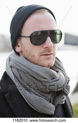 Stock Image - Hipster in grey scarf and sunglasses. Fotosearch