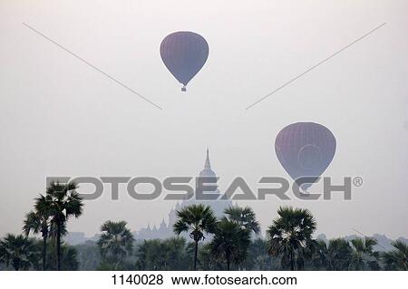 Stock Photo - Hot air balloons in the sky of Bagan, temple in the background, Burma. Fotosearch