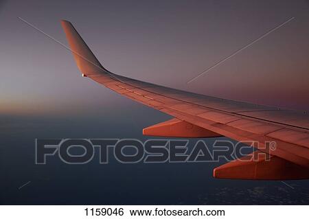 Jet above the clouds at dusk View Large Photo Image Stock Photograph - Jet above the clouds at dusk. Fotosearch