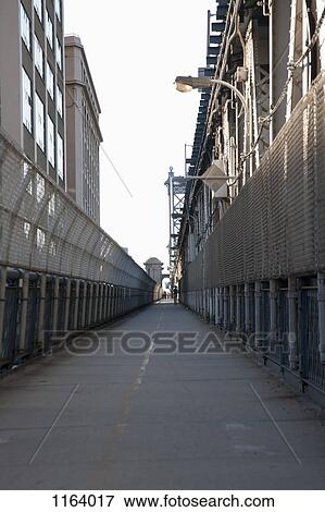 Jogger on pedestrian walkway on Manhattan Bridge View Large Photo Image Stock Photo - Jogger on pedestrian walkway on Manhattan Bridge. Fotosearch