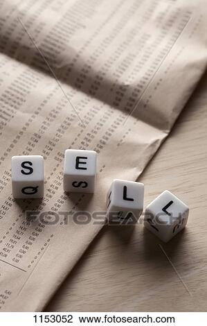 Stock Image - Lettered cubes spelling SELL lying on top of a financial page. Fotosearch
