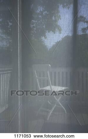Stock Image - Looking through a transparent curtain onto a deck . Fotosearch