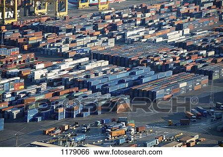 Lorries loading cargo containers at the docks in Barcelona, Spain View Large Photo Image Stock Photograph - Lorries loading cargo containers at the docks in Barcelona, Spain. Fotosearch