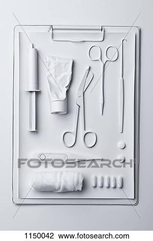Stock Image - Medicine and medical equipment painted white and laid out on a clipboard. Fotosearch