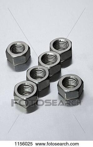 Metal nuts arranged in a pattern View Large Photo Image Stock Photography - Metal nuts arranged in a pattern. Fotosearch