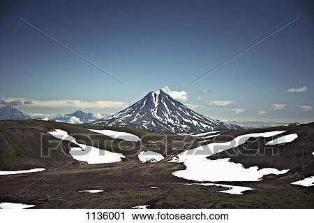 Patches of snow in a valley in front of Koryaksky Volcano, Russia View Large Photo Image Stock Image - Patches of snow in a valley in front of Koryaksky Volcano, Russia. Fotosearch