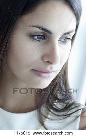 Stock Photography - Pensive woman with reflection in her eyes. Fotosearch