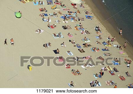 People relaxing on beach View Large Photo Image Stock Image - People relaxing on beach. Fotosearch