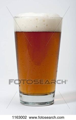 Pint of frothy beer View Large Photo Image Stock Image - Pint of frothy beer. Fotosearch