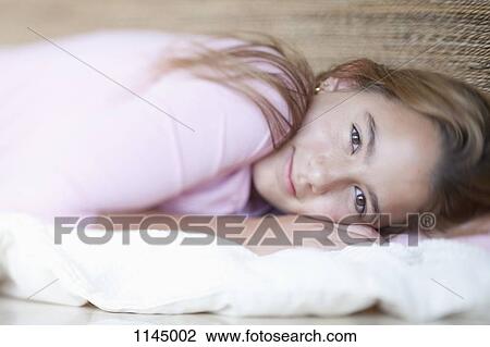 Stock Image - Portrait girl lying down. Fotosearch