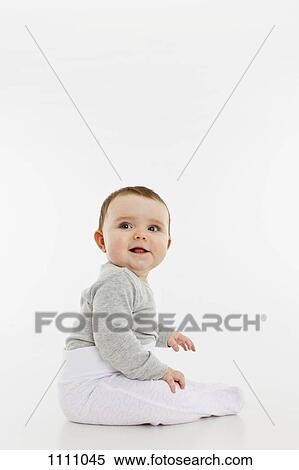 Portrait of a baby girl sitting View Large Photo Image Stock Photography - Portrait of a baby girl sitting. Fotosearch