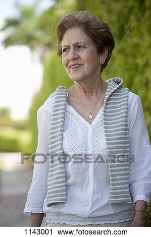 Portrait of a senior woman looking away View Large Photo Image Stock Image - Portrait of a senior woman looking away. Fotosearch