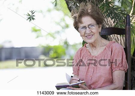 Portrait of a senior woman writing in a book View Large Photo Image Stock Photo - Portrait of a senior woman writing in a book. Fotosearch