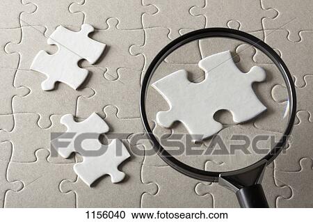 Puzzle pieces on a jigsaw puzzle being magnified by a magnifying glass View Large Photo Image Stock Image - Puzzle pieces on a jigsaw puzzle being magnified by a magnifying glass. Fotosearch