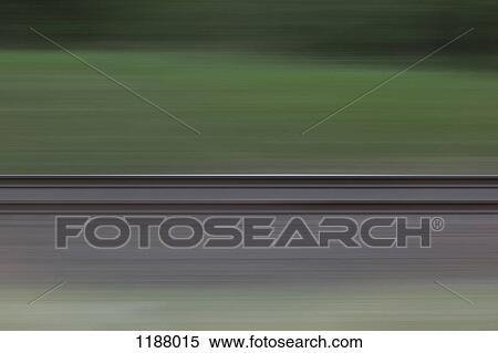 Stock Photography - Railroad tracks and grass seen in blurred abstract pattern from moving train. Fotosearch
