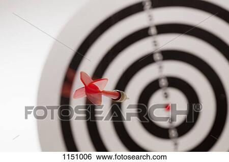 Rear view of a dart flying towards the bull's eye of a target View Large Photo Image Stock Photograph - Rear view of a dart flying towards the bull's eye of a target. Fotosearch
