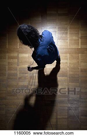 Stock Photography - Rock singer on stage in spotlight. Fotosearch
