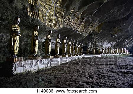 Stock Photograph - Rows of Buddha statues in Saddar Cave, Hpa-An, Burma. Fotosearch