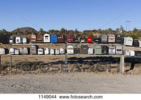 Rows of mailboxes next to a dirt road in a desert View Large Photo Image Picture - Rows of mailboxes next to a dirt road in a desert. Fotosearch