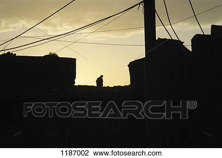 Silhouetted man on roof top View Large Photo Image Stock Image - Silhouetted man on roof top. Fotosearch