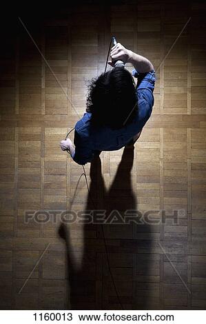 Stock Image - Singer in the spotlight. Fotosearch