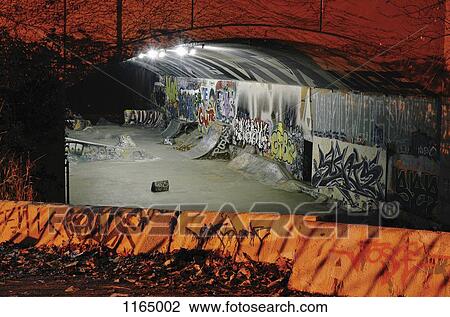 Skateboarding ramps and graffiti in a tunnel at night View Large Photo Image Stock Image - Skateboarding ramps and graffiti in a tunnel at night. Fotosearch