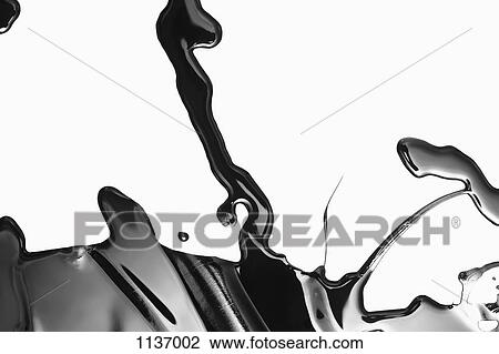 Stock Image - Spilled black paint making an abstract shape on white background. Fotosearch