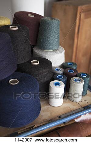 Spools of cotton on a workbench View Large Photo Image Stock Photo - Spools of cotton on a workbench. Fotosearch