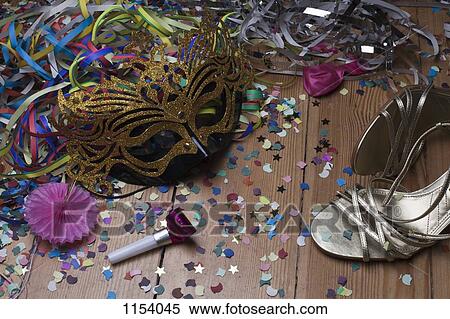 Stock Photography - Strappy heels and party decorations littering a hardwood floor. Fotosearch