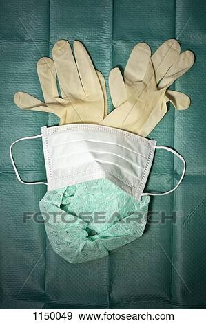 Surgical mask, cap and gloves arranged on a surgical drape View Large Photo Image Stock Photo - Surgical mask, cap and gloves arranged on a surgical drape. Fotosearch