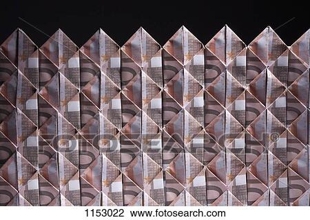 Stock Image - Ten Euro banknotes folded into diamond shapes and interwoven. Fotosearch