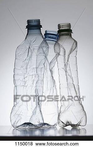Three empty, partially crushed plastic water bottles View Large Photo Image Stock Photo - Three empty, partially crushed plastic water bottles. Fotosearch