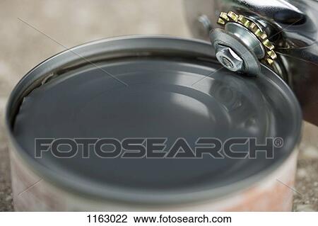 Tin opener opening canned food View Large Photo Image Stock Image - Tin opener opening canned food. Fotosearch