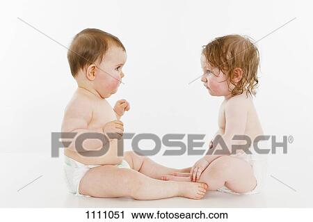 Two babies sitting together View Large Photo Image Stock Image - Two babies sitting together. Fotosearch