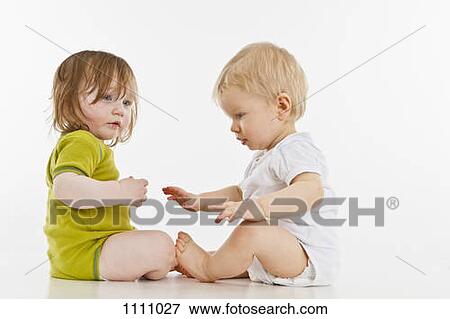 Stock Photo - Two babies sitting together. Fotosearch