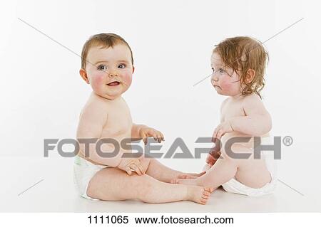 Stock Photography - Two babies sitting together. Fotosearch