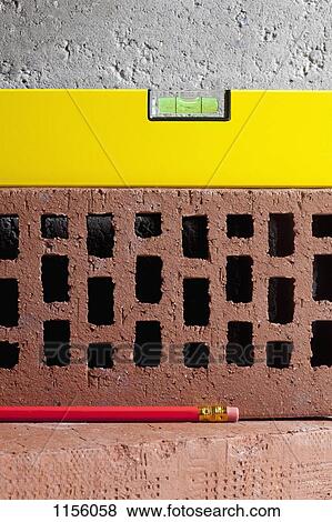 Two bricks, a pencil and a level View Large Photo Image Stock Photo - Two bricks, a pencil and a level. Fotosearch