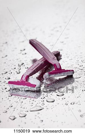 Two disposable razors with shaving cream on them View Large Photo Image Stock Photo - Two disposable razors with shaving cream on them. Fotosearch