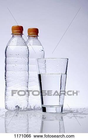 Stock Photograph - Two full plastic water bottles and a drinking glass. Fotosearch