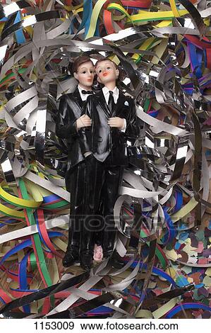 Two male figurines lying on confetti and streamers View Large Photo Image Stock Photo - Two male figurines lying on confetti and streamers. Fotosearch