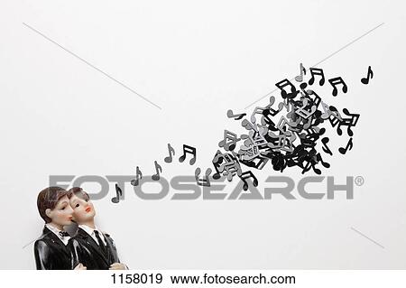 Two male figurines next to a group of musical notes View Large Photo Image Stock Photo - Two male figurines next to a group of musical notes. Fotosearch
